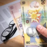 Calculatrice posée sur des billets euros et un livret épargne bancaire