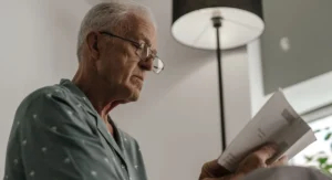 Senior consultant reviewing retirement documents at office desk France